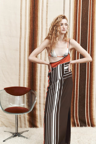 Brown and orange striped maxi slip dress with thin straps.