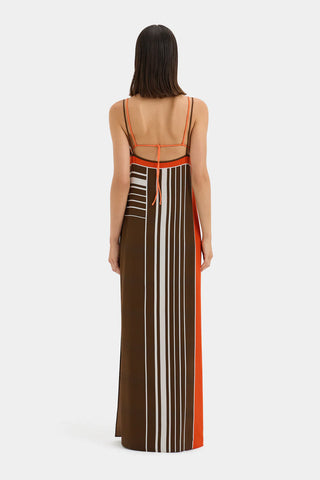 Brown and orange striped maxi slip dress with thin straps.