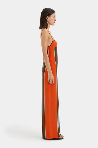 Brown and orange striped maxi slip dress with thin straps.