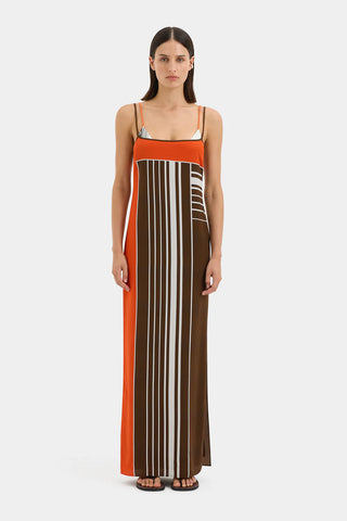 Brown and orange striped maxi slip dress with thin straps.