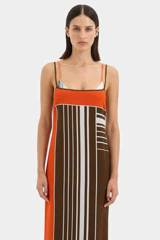 Brown and orange striped maxi slip dress with thin straps.