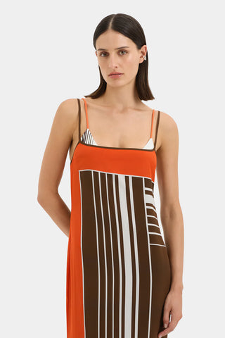 Brown and orange striped maxi slip dress with thin straps.