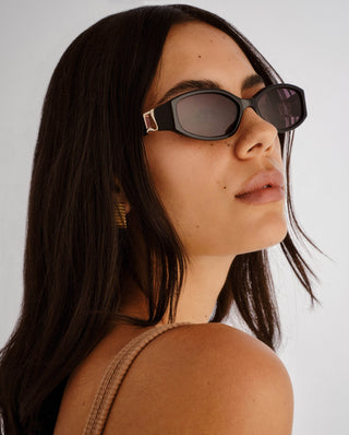 Black sunglasses with a gold hardware, the luv lou lottie in black